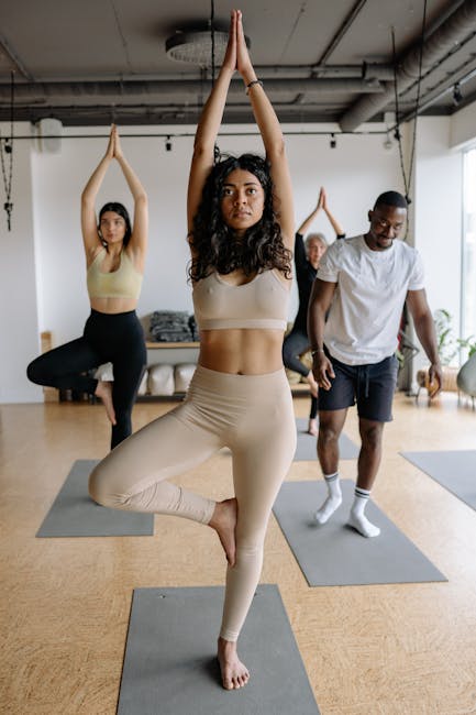 Group of diverse individuals practicing yoga in a modern studio environment.